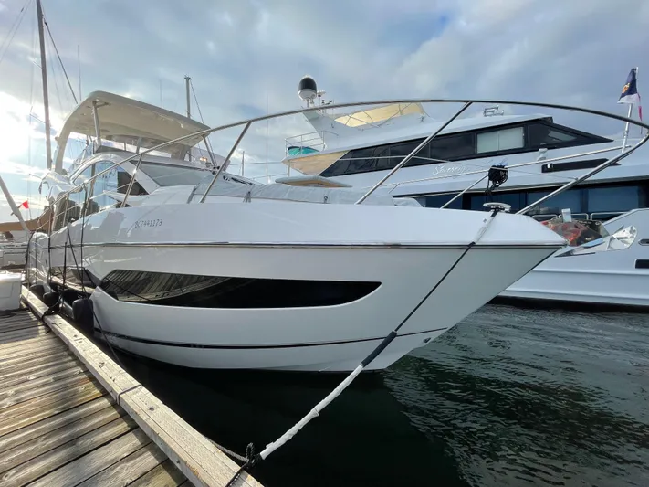 Sea Sea V Yacht Photos Pics 2020 Sunseeker Manhattan 52 yacht docked at marina under cloudy sky.