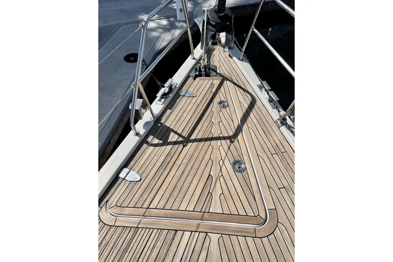 The Jonathan Shepard Yacht Photos Pics Deck of 2006 Hanse 461e sailboat with teak wood finish and metal railings.