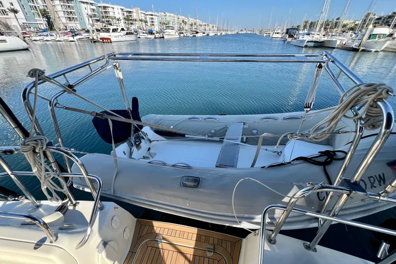 The Jonathan Shepard Yacht Photos Pics 2006 Hanse 461e yacht with dinghy in marina, surrounded by boats and waterfront buildings.