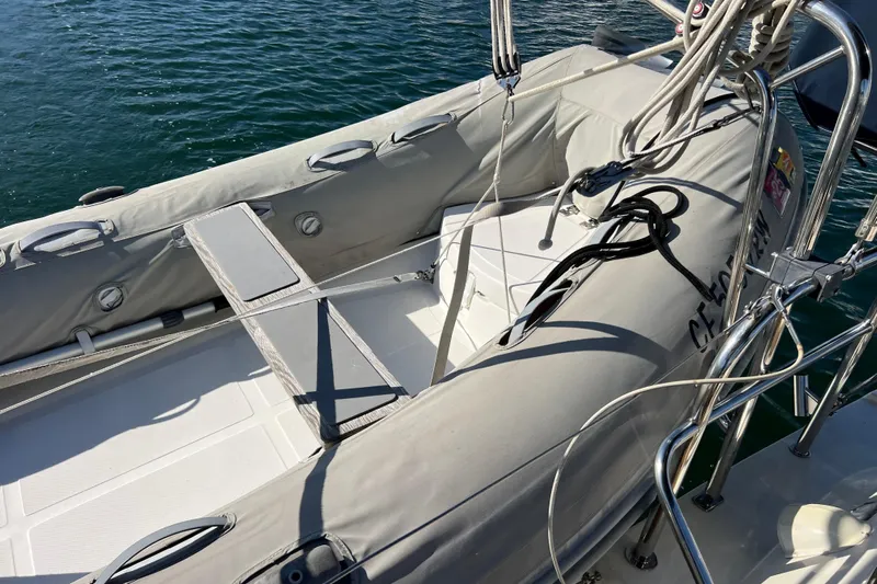 The Jonathan Shepard Yacht Photos Pics Inflatable dinghy on 2006 Hanse 461e yacht, docked on calm water.