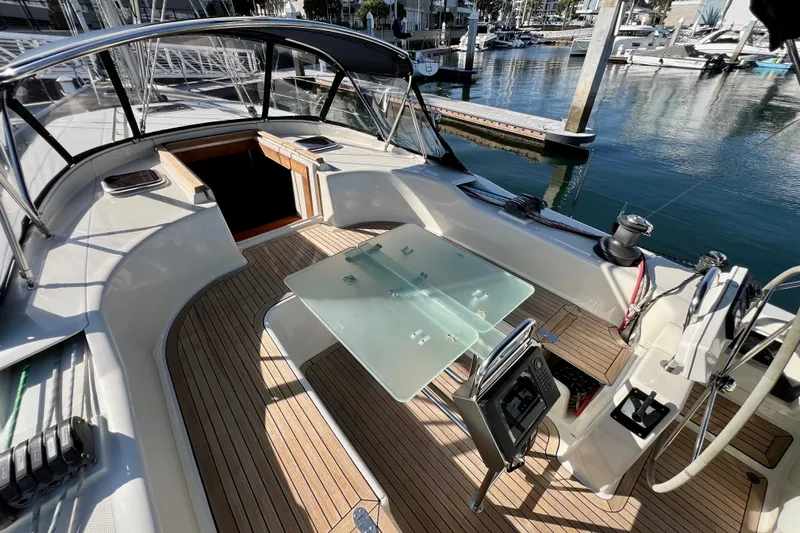 The Jonathan Shepard Yacht Photos Pics 2006 Hanse 461e yacht cockpit with teak flooring and glass table, docked at marina.