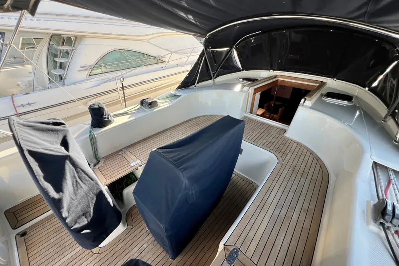 The Jonathan Shepard Yacht Photos Pics 2006 Hanse 461e yacht cockpit with teak flooring and covered seating.