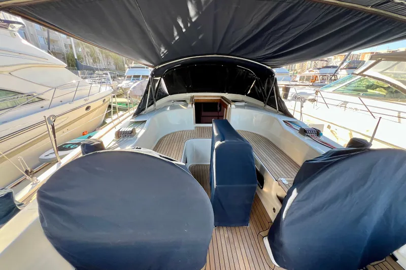 The Jonathan Shepard Yacht Photos Pics 2006 Hanse 461e yacht cockpit with covered seating, docked among other boats.