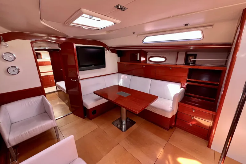 The Jonathan Shepard Yacht Photos Pics Luxurious interior of 2006 Hanse 461e yacht with elegant wood finish and seating area.