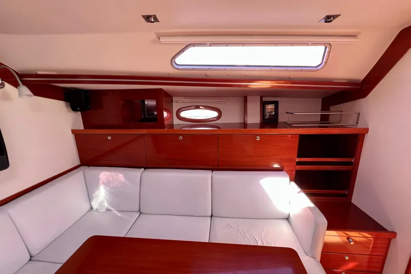 The Jonathan Shepard Yacht Photos Pics Interior of 2006 Hanse 461e yacht with white seating and wooden cabinetry.