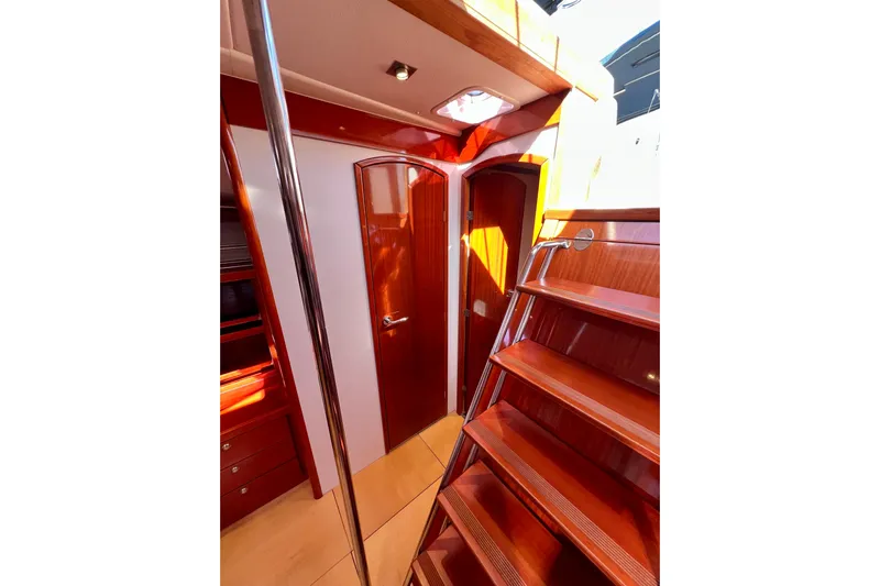 The Jonathan Shepard Yacht Photos Pics Interior of 2006 Hanse 461e yacht with polished wood finish and staircase.