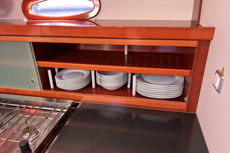 The Jonathan Shepard Yacht Photos Pics Wooden yacht kitchen with neatly stacked plates, Hanse 461e, 2006 model.