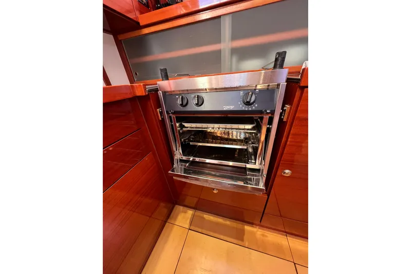 The Jonathan Shepard Yacht Photos Pics Stainless steel oven in a 2006 Hanse 461e yacht kitchen with wooden cabinetry.