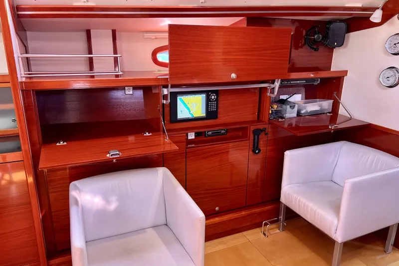 The Jonathan Shepard Yacht Photos Pics Interior of 2006 Hanse 461e yacht with navigation equipment and white chairs.
