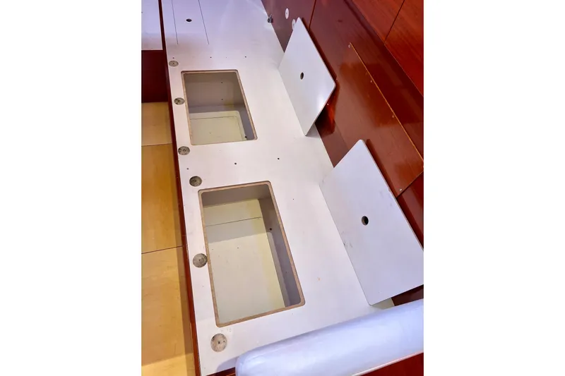 The Jonathan Shepard Yacht Photos Pics Interior storage compartments on a 2006 Hanse 461e yacht, featuring wooden finish and open lids.