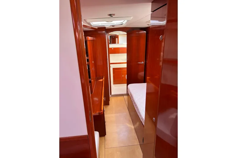 The Jonathan Shepard Yacht Photos Pics Luxurious wooden interior of 2006 Hanse 461e yacht cabin with bed and storage.