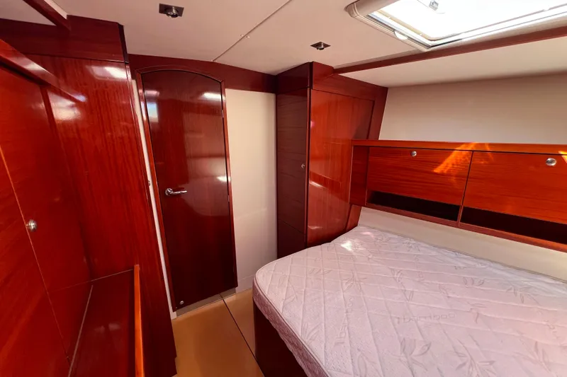The Jonathan Shepard Yacht Photos Pics Luxurious wooden interior of 2006 Hanse 461e yacht cabin with bed and storage.