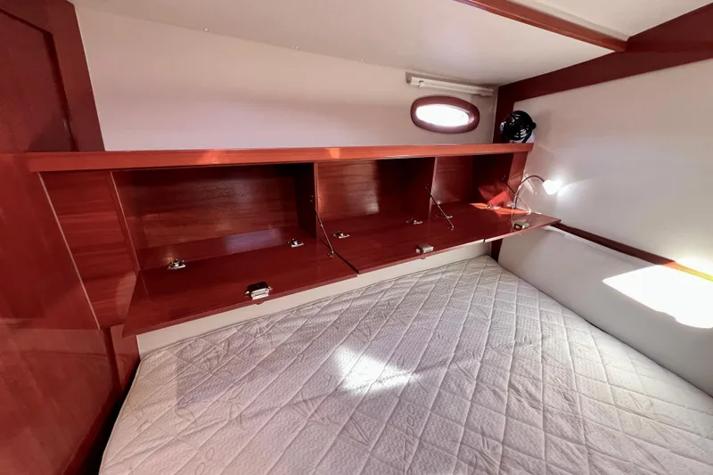 The Jonathan Shepard Yacht Photos Pics Interior cabin of 2006 Hanse 461e yacht with wooden storage and bed.