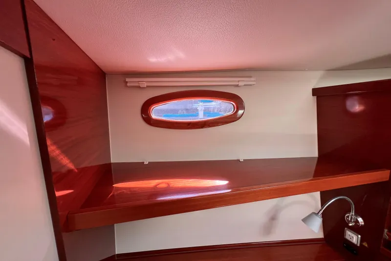 The Jonathan Shepard Yacht Photos Pics Interior of 2006 Hanse 461e yacht with wooden finish and porthole window.