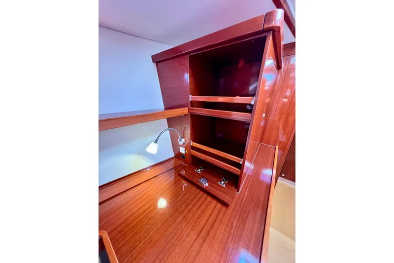 The Jonathan Shepard Yacht Photos Pics Wooden interior of 2006 Hanse 461e yacht with shelves and reading lamp.