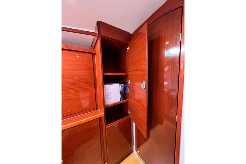 The Jonathan Shepard Yacht Photos Pics Wooden cabinet interior on 2006 Hanse 461e yacht, featuring shelves and storage space.