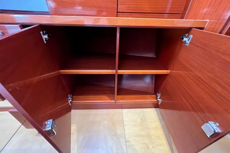The Jonathan Shepard Yacht Photos Pics Open wooden cabinet with shelves inside, part of a 2006 Hanse 461e model.