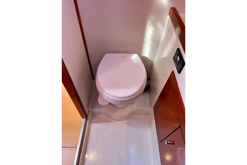 The Jonathan Shepard Yacht Photos Pics Compact bathroom in 2006 Hanse 461e yacht with modern toilet and wooden cabinetry.