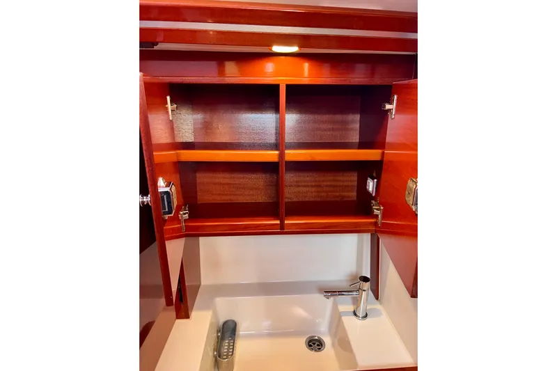 The Jonathan Shepard Yacht Photos Pics Wooden cabinet and sink in 2006 Hanse 461e yacht bathroom.
