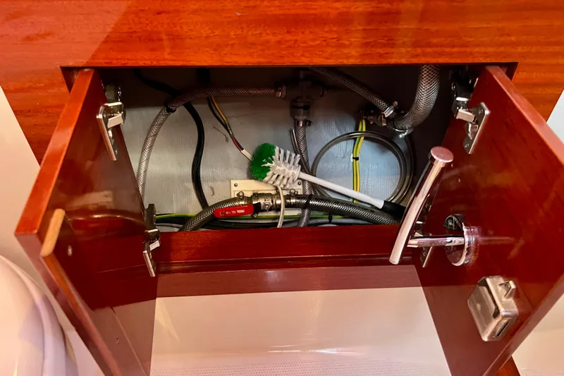 The Jonathan Shepard Yacht Photos Pics Open cabinet in 2006 Hanse 461e yacht showing plumbing and wiring.