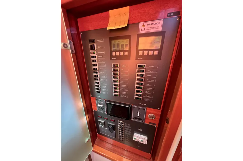 The Jonathan Shepard Yacht Photos Pics Electrical control panel on a 2006 Hanse 461e yacht, featuring switches and displays.