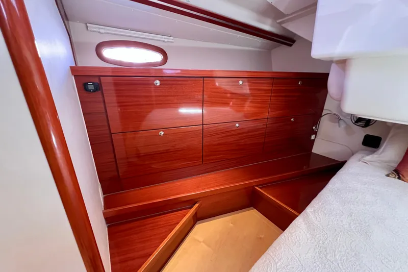 The Jonathan Shepard Yacht Photos Pics Interior of 2006 Hanse 461e yacht with polished wood cabinetry and cozy sleeping area.