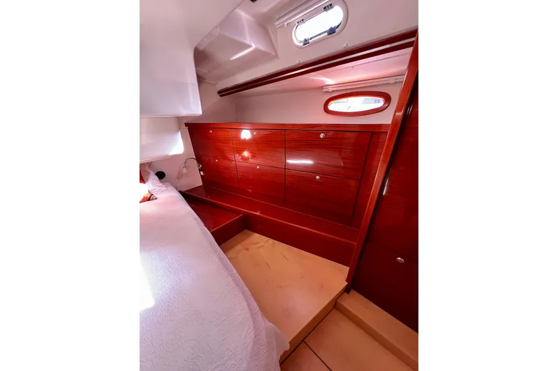 The Jonathan Shepard Yacht Photos Pics Luxurious cabin interior of 2006 Hanse 461e yacht with wooden cabinetry and cozy bed.