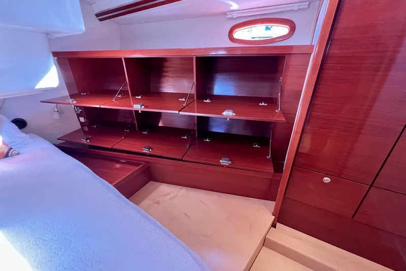 The Jonathan Shepard Yacht Photos Pics Interior of 2006 Hanse 461e yacht with open wooden cabinets and bed.