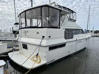 Grace Yacht Photos Pics 1995 Carver 440 Aft Cabin Motor Yacht docked in marina, side view.