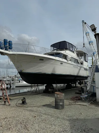 Grace Yacht Photos Pics 1995 Carver 440 Aft Cabin Motor Yacht on dry dock, marina background.