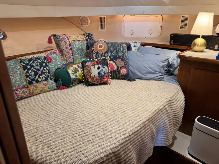 Grace Yacht Photos Pics Cozy cabin interior of 1995 Carver 440 Aft Cabin Motor Yacht with colorful pillows and lamp.