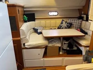 Grace Yacht Photos Pics Interior of 1995 Carver 440 Aft Cabin Motor Yacht with cozy seating and table.