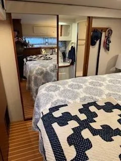 Grace Yacht Photos Pics Interior of 1995 Carver 440 Aft Cabin Motor Yacht with cozy bedroom and patterned bedding.