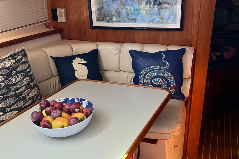 Grace Yacht Photos Pics 1995 Carver 440 Aft Cabin Motor Yacht interior with cushioned seating and decorative pillows.