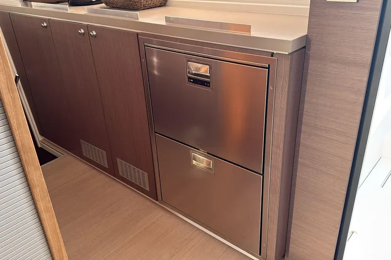  Yacht Photos Pics Modern kitchen cabinetry with stainless steel appliances on a 2021 Bali 5.4 yacht.