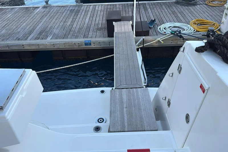  Yacht Photos Pics Bali 5.4 yacht docked, featuring a wooden gangway and deck, 2021 model.