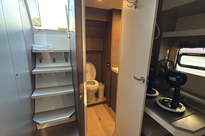  Yacht Photos Pics Modern bathroom interior on a 2021 Bali 5.4 yacht, featuring shelves and a compact toilet.