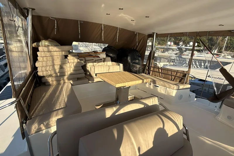  Yacht Photos Pics Luxurious Bali 5.4 yacht interior with cushioned seating and table, 2021 model.