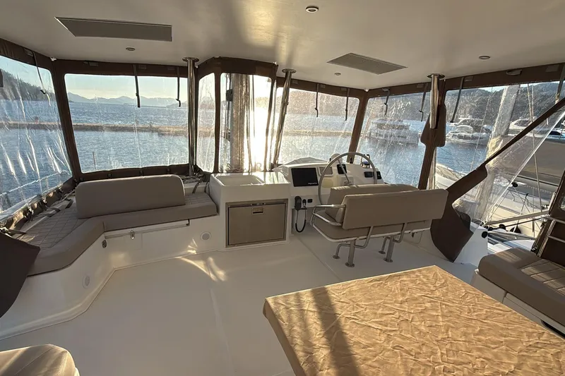  Yacht Photos Pics Spacious interior of 2021 Bali 5.4 catamaran with panoramic windows and comfortable seating.