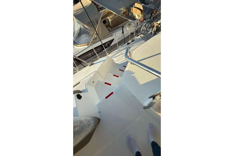  Yacht Photos Pics Stairs on a 2021 Bali 5.4 yacht deck with railing and red accents.