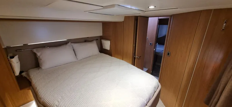  Yacht Photos Pics Luxurious bedroom interior of 2024 Bali 5.4 yacht with cozy bed and modern design.