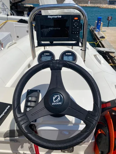  Yacht Photos Pics Steering wheel and dashboard of a 2024 Bali 5.4 boat with Raymarine display.