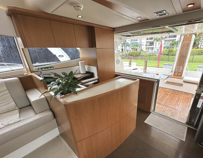 Primo Yacht Photos Pics Luxurious interior of 2014 Ferretti Yachts 530 with modern wood finishes and open deck view.
