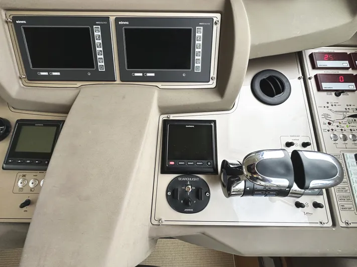 Primo Yacht Photos Pics Control panel of a 2014 Ferretti Yachts 530 with navigation screens and throttle controls.