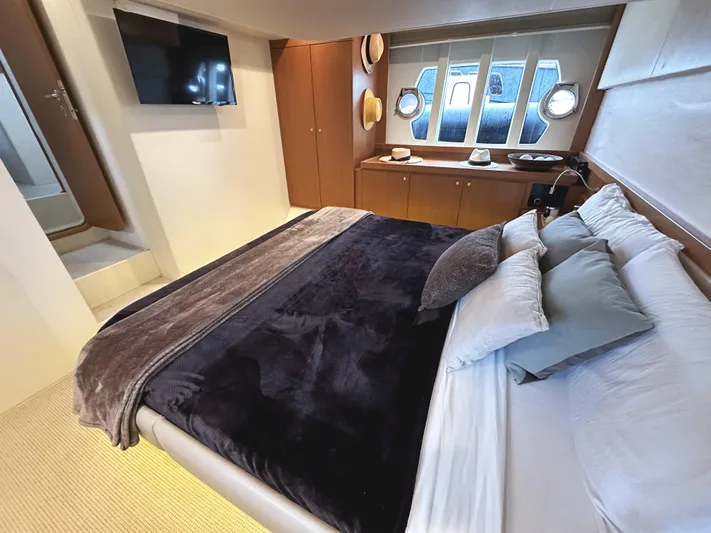 Primo Yacht Photos Pics Luxurious bedroom in 2014 Ferretti Yachts 530 with modern decor and cozy bedding.