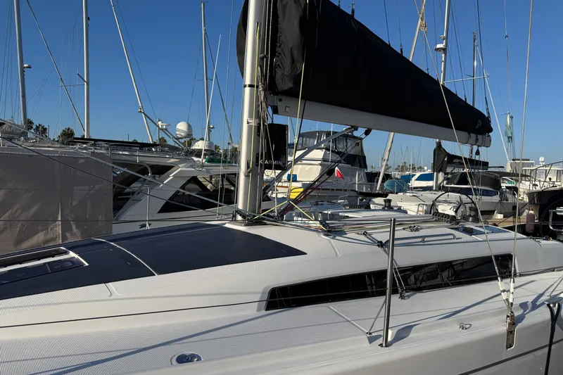  Yacht Photos Pics 2023 Beneteau First 36 sailboat docked in a marina, showcasing sleek design and modern features.