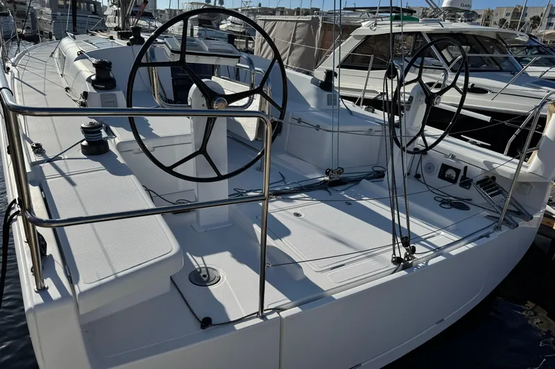  Yacht Photos Pics 2023 Beneteau First 36 sailboat cockpit with dual steering wheels, docked at marina.