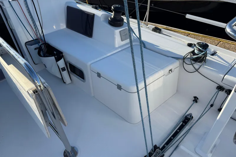  Yacht Photos Pics 2023 Beneteau First 36 sailboat cockpit with ropes, winches, and storage compartments.