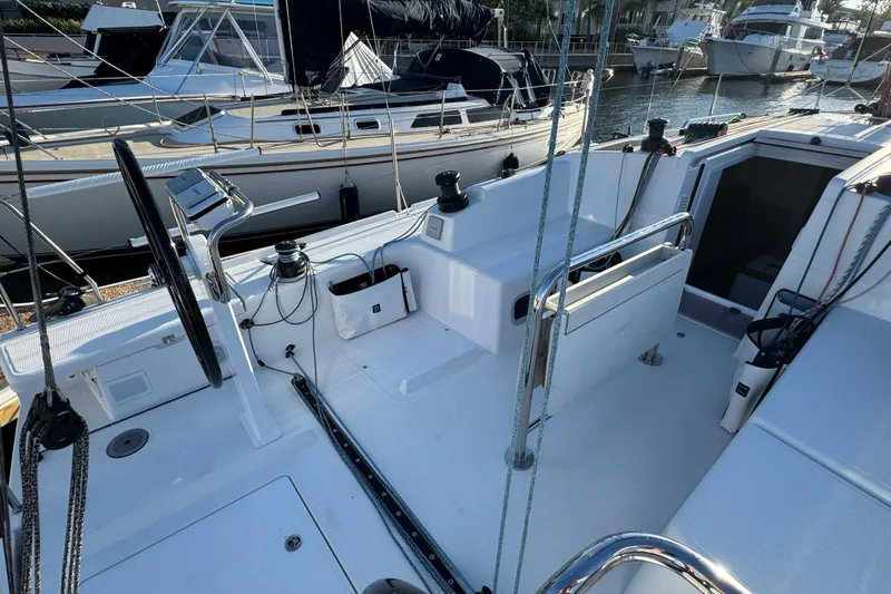  Yacht Photos Pics 2023 Beneteau First 36 sailboat cockpit with steering wheel and winches, docked in marina.