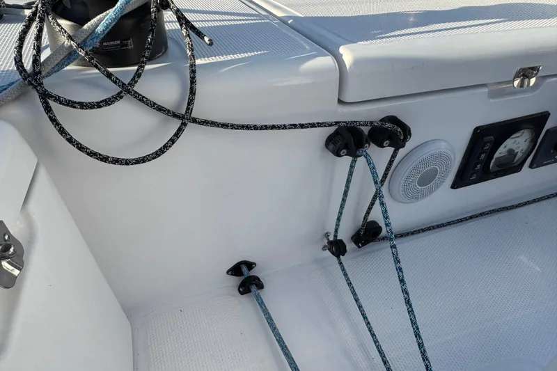  Yacht Photos Pics 2023 Beneteau First 36 sailboat cockpit with ropes, winch, and control panel.